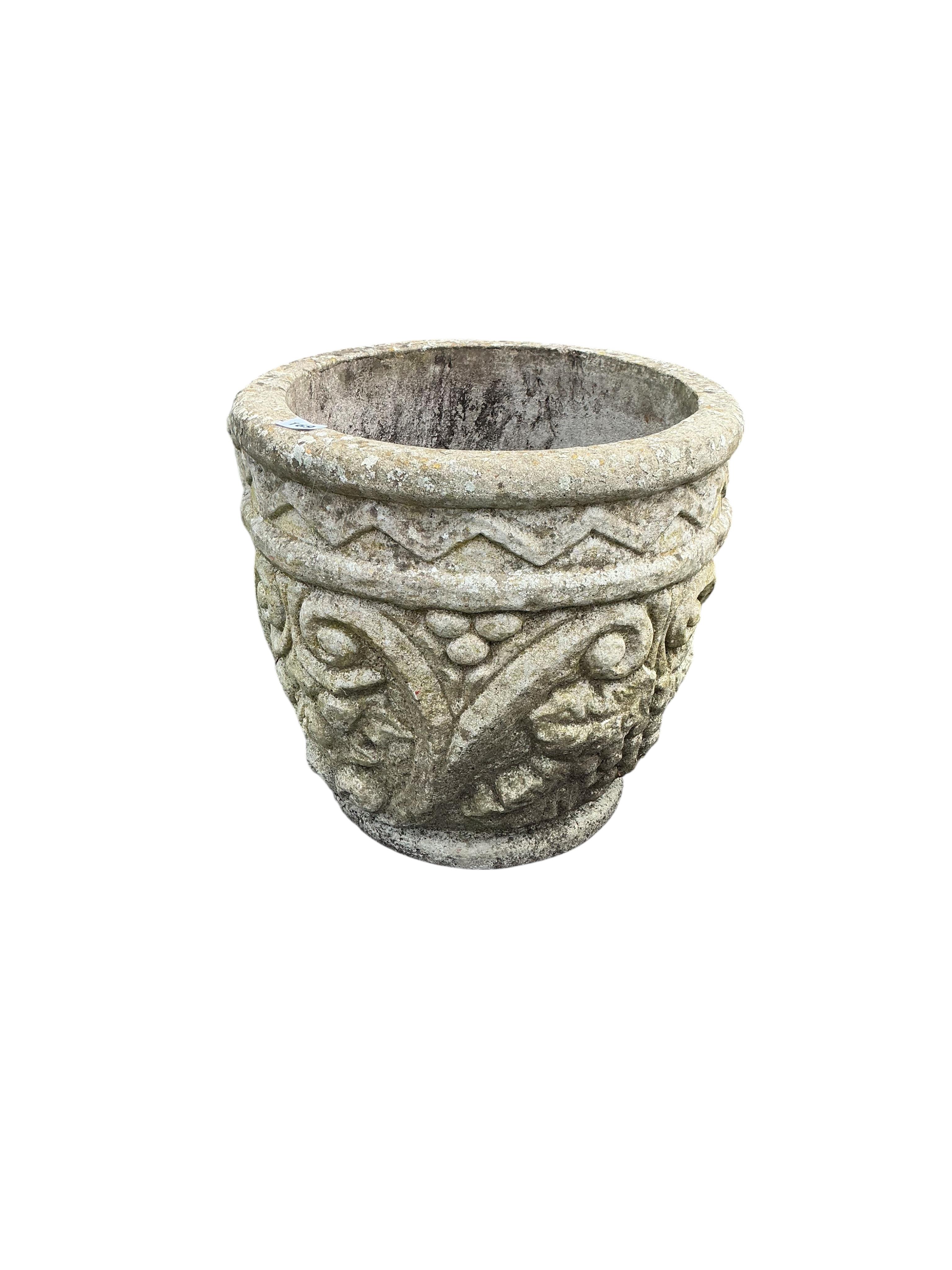 A pair of circular reconstituted stone garden planters with fruiting vine moulded bodies, diameter 40cm, height 38cm